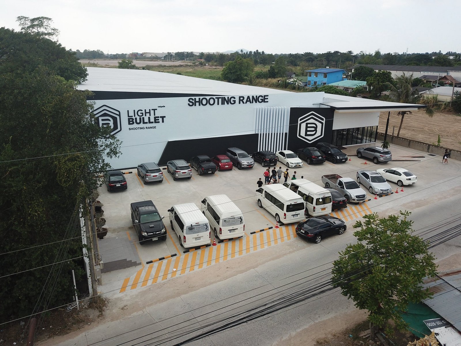A group arriving by minibus at Light Bullet Shooting Range with ample coach parking