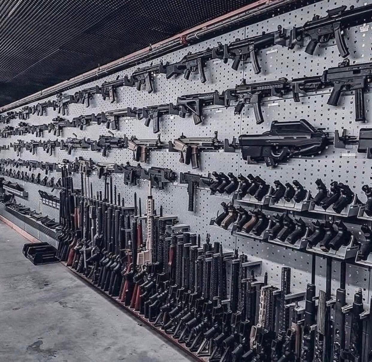 A large wall of firearms available at Light Bullet shooting range