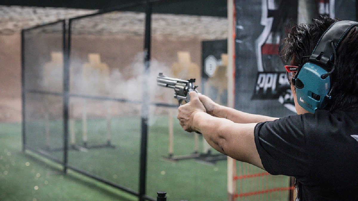 A visitor firing a revolver downrange at Light Bullet